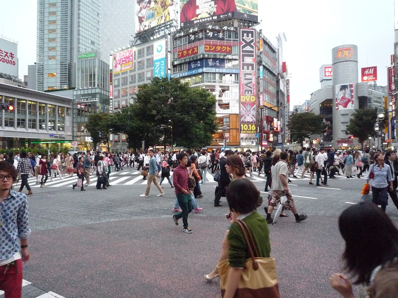 Crowds of pedestrians crossing the famous Shibuya scramble crossing in Tokyo