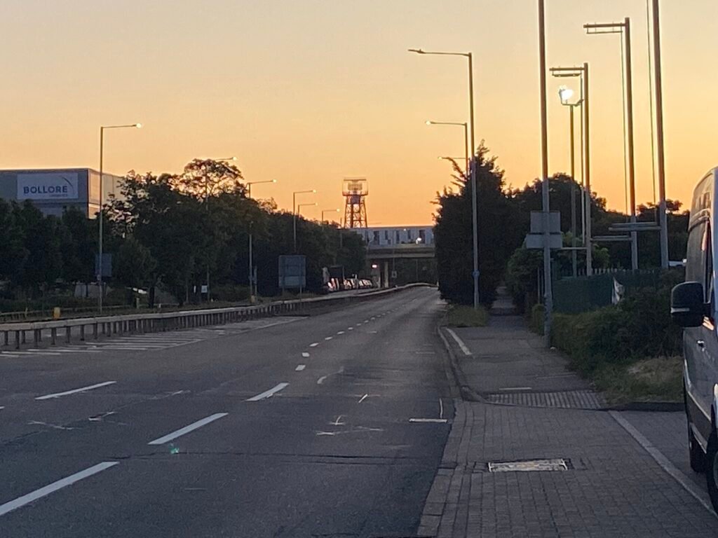 The air traffic control tower at London Heathrow Airport against a clear sky