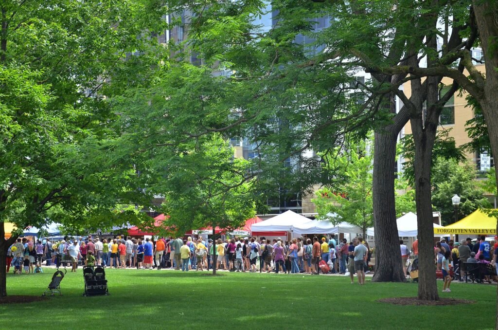 Crowds browsing produce stalls at the Dane County Farmers' Market around Capitol Square