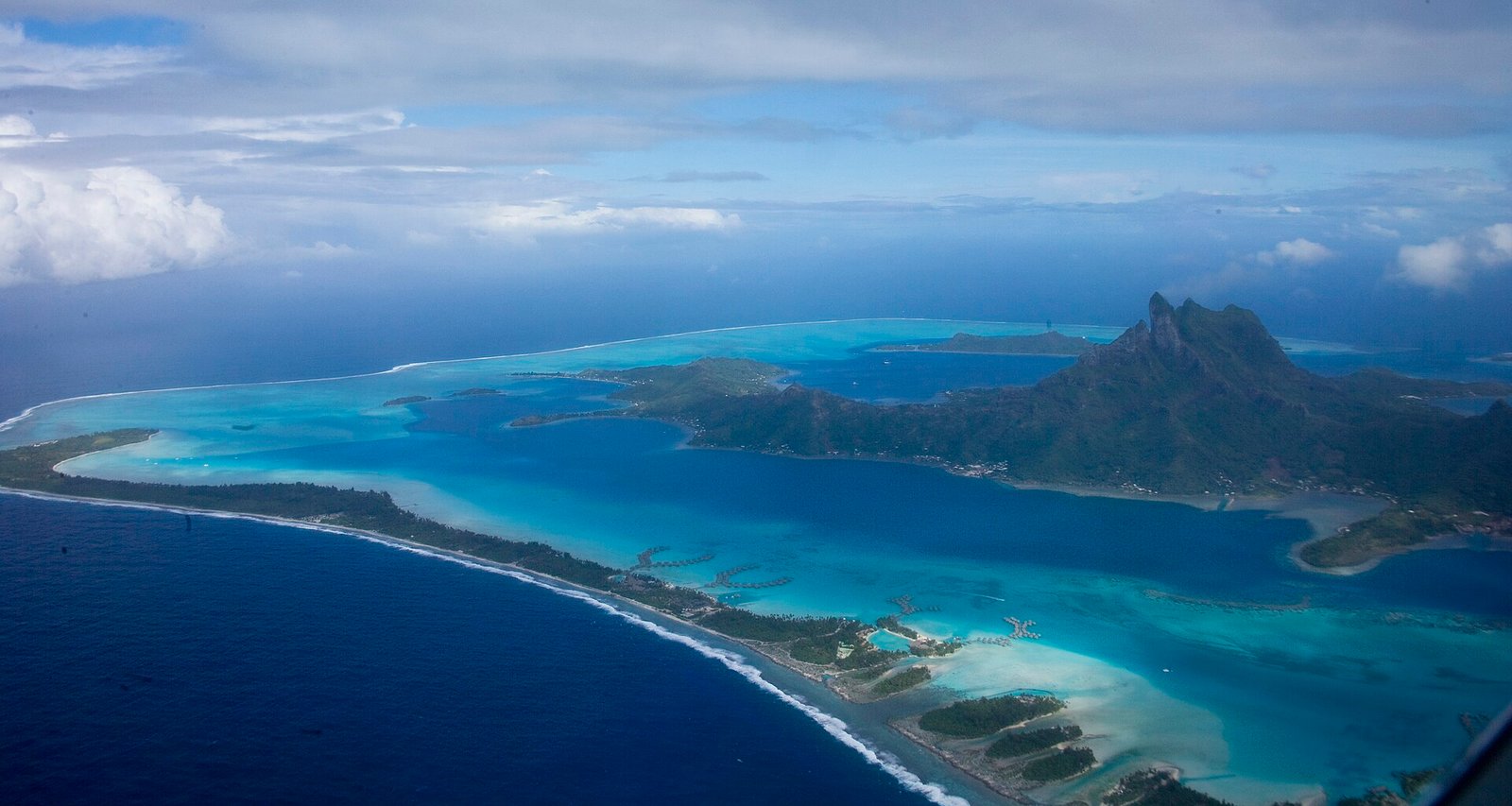 Turquoise lagoon of Bora Bora with Mount Otemanu rising behind the overwater bungalows