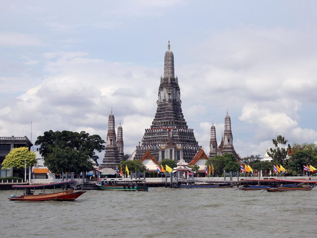 Wat Arun temple on the Chao Phraya river in Bangkok at dusk